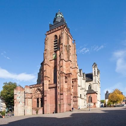 Wetzlar Cathedral with red sandstone tower Wetzlar Cathedral featuring a tall red sandstone tower with Gothic architecture, surrounded by historic buildings on a cobblestone square.